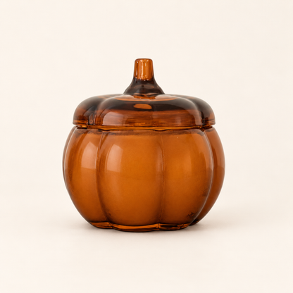 Small Pumpkin candle in a smooth, ribbed amber glass pumpkin jar with a stem-handled lid